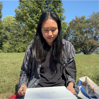 Creator of Little Letter Club drawing at the park