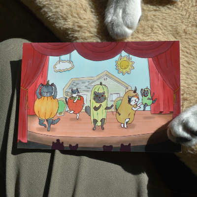 Closeup of postcard featuring cats in veggie costumes