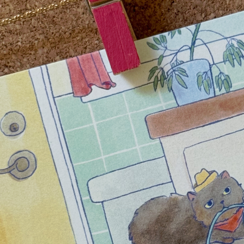 Closeup of featuring a cat in a cowboy hat with yarn in its mouth